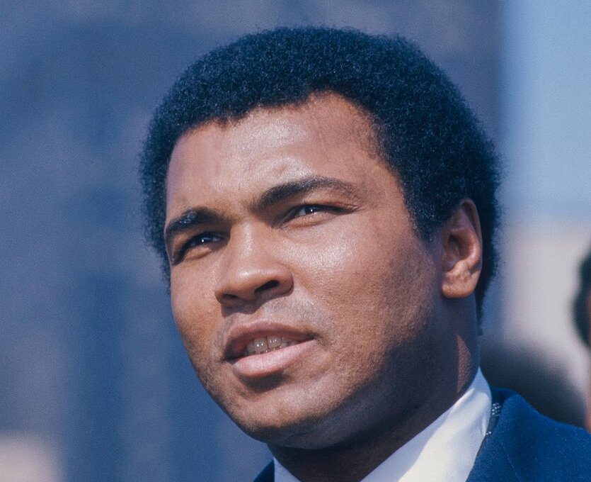 Portrait Photo of Muhammad Ali wearing blue suit