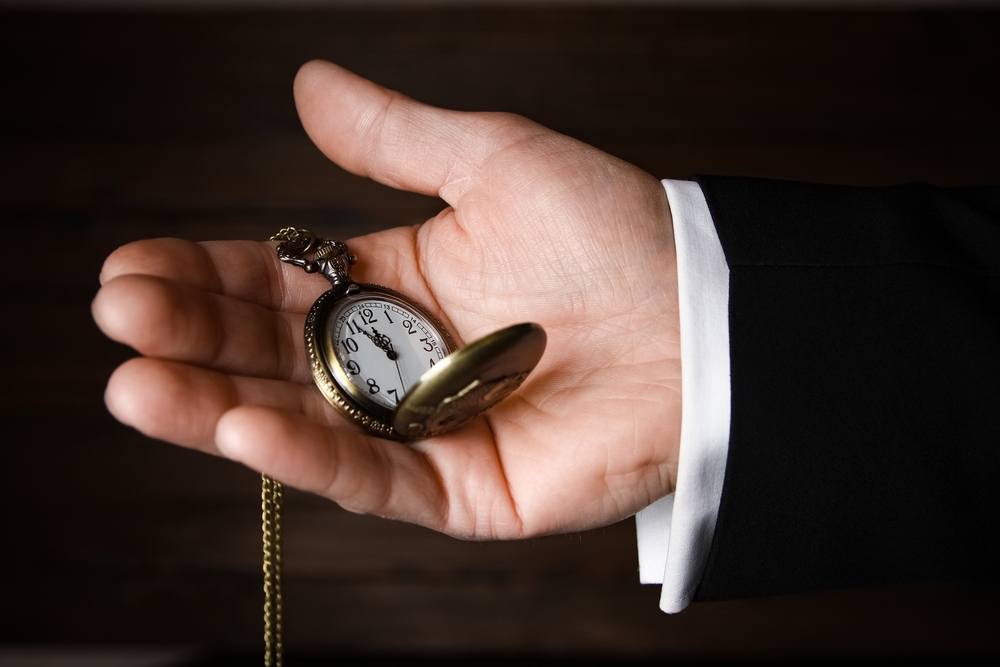 Pocket watch in the hands of a man.