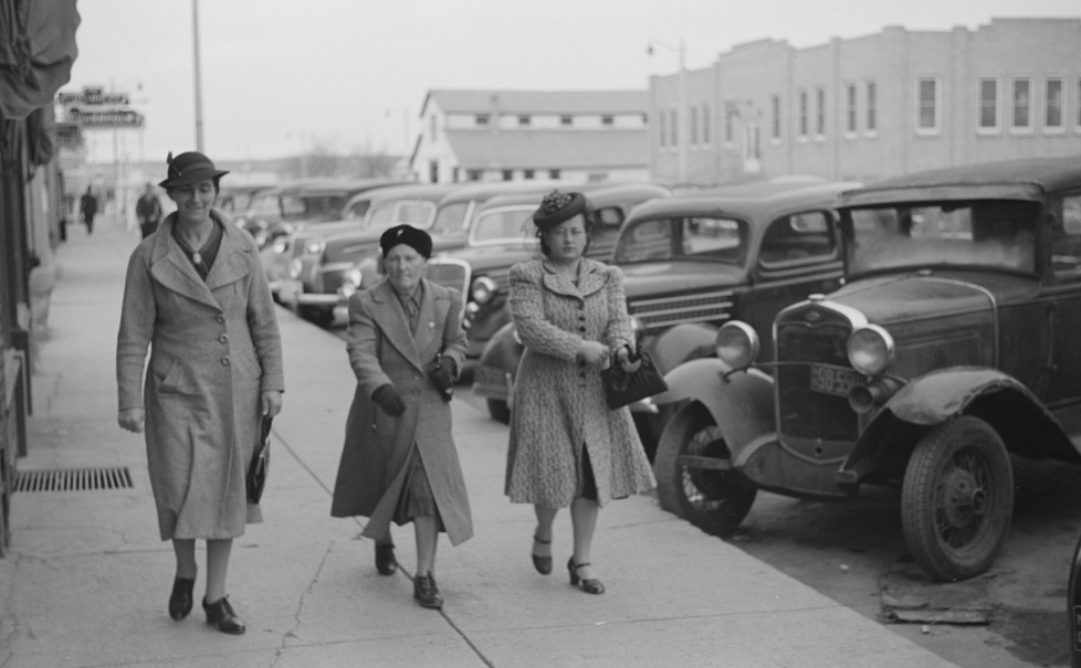 Women Walking Down A Sidewalk