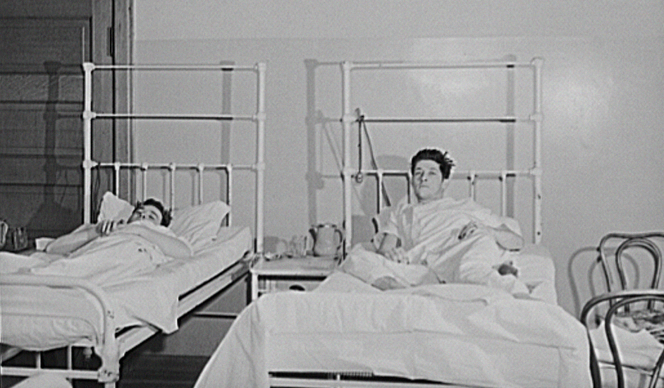 Men laying in a hospital