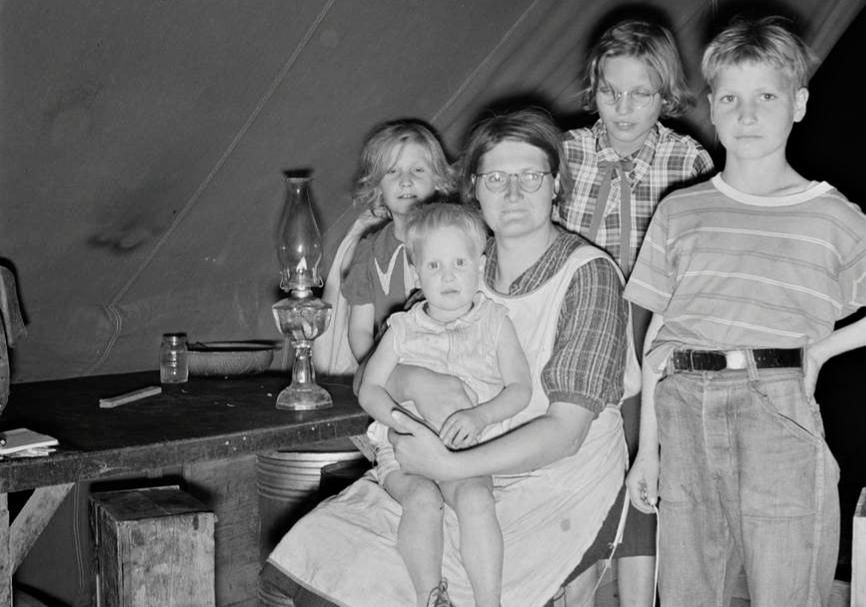 Family of six in tent after supper