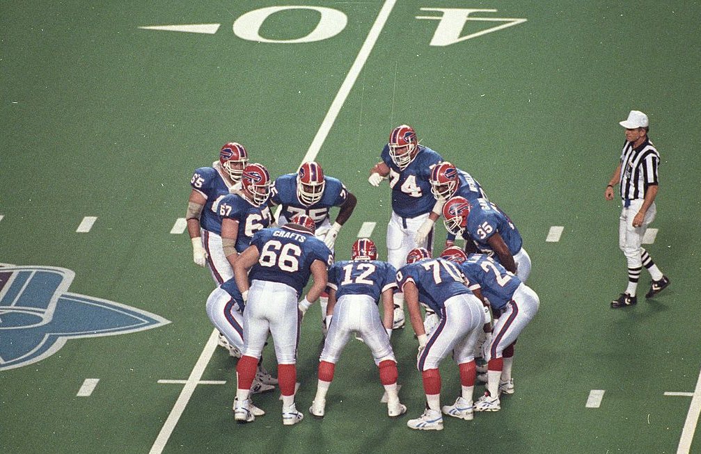 Quarterback Jim Kelly #12 of the Buffalo Bills huddles with his teammates