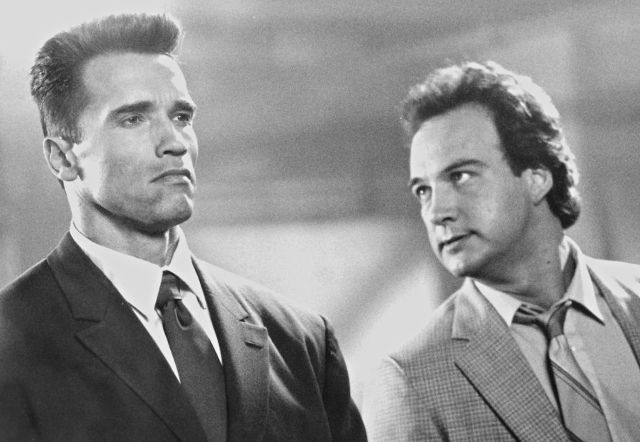 Actors James Belushi and Arnold Schwarzenegger on a set