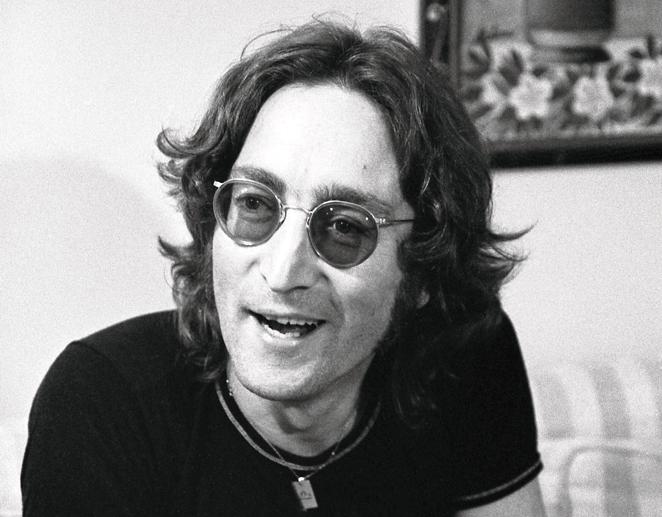 Grayscale Portrait Photo of John Lennon in dark outfit
