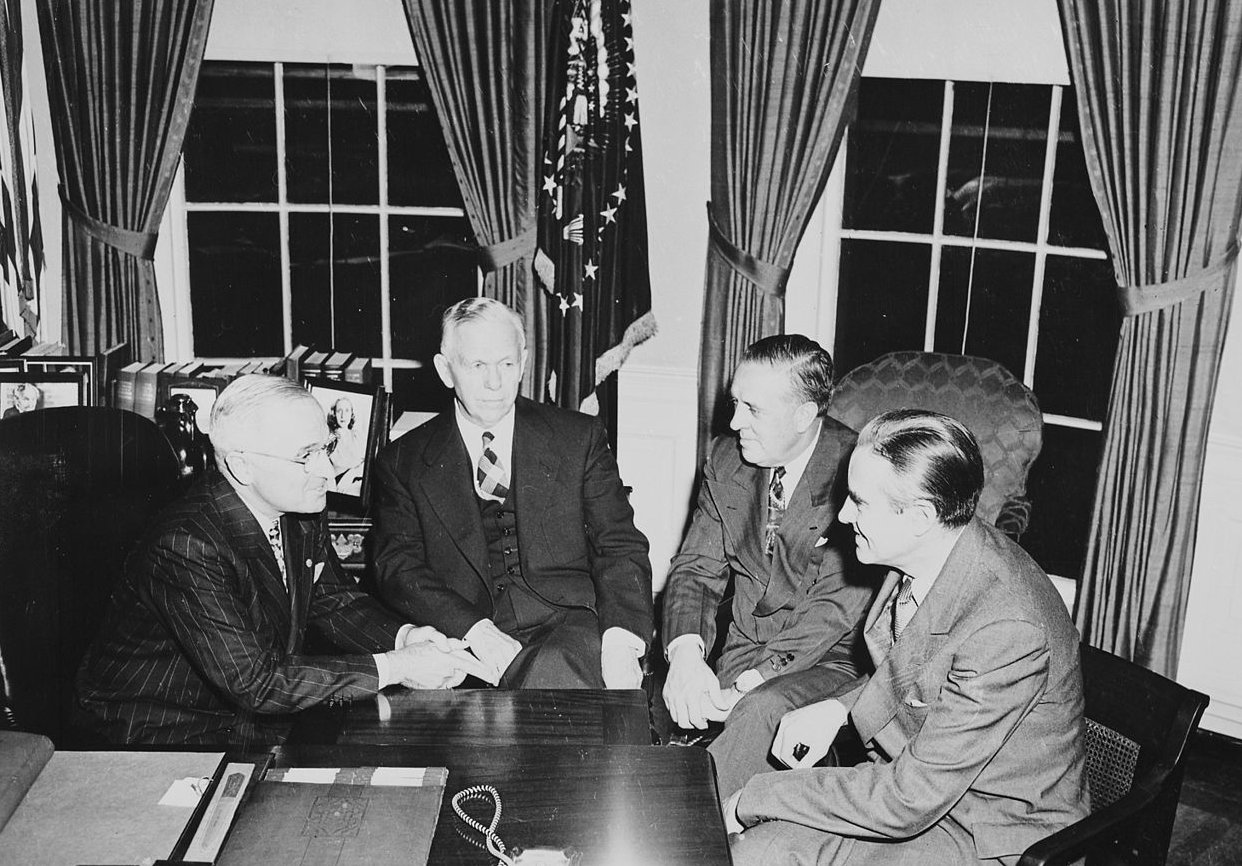 President Truman, George C. Marshall, Paul Hoffman, and Averell Harriman in the oval office discussing the Marshall Plan