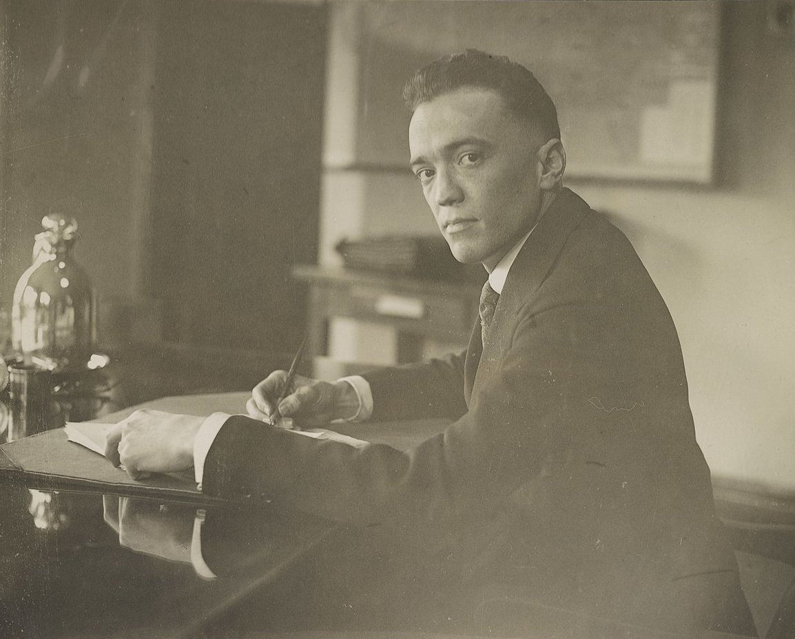 J. Edgar Hoover posing for a photo at the desk