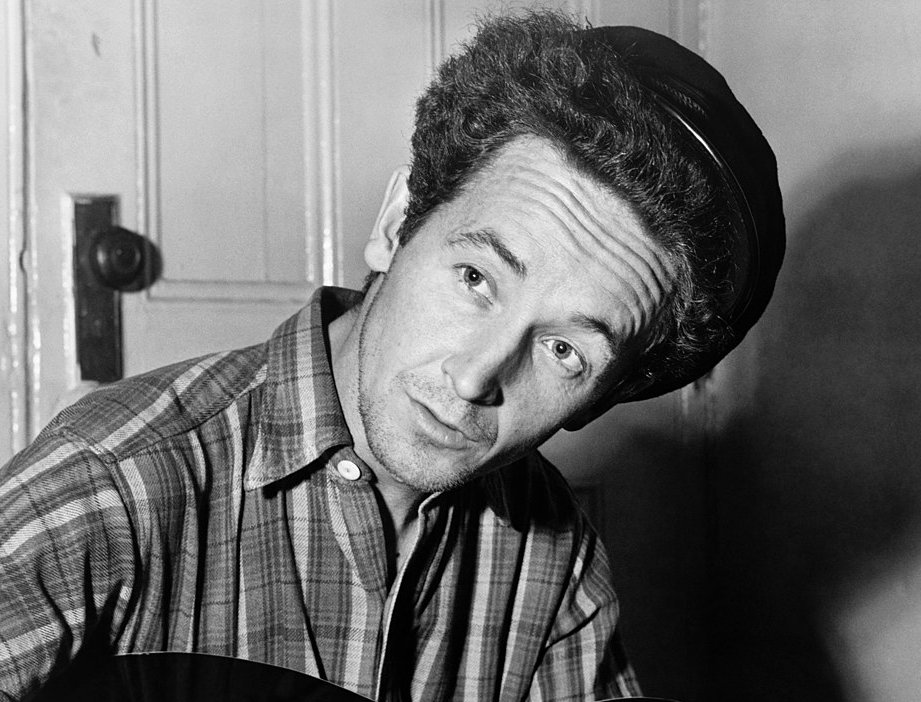 Grayscale Portrait Photo of Woody Guthrie looking to the left