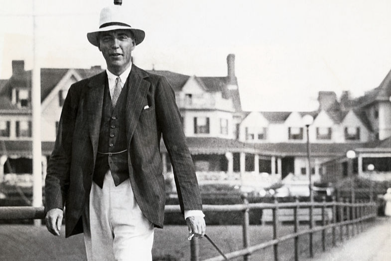Vince Astor Walks the Dog. Marblehead, Massachusetts. Vincent Astor is pictured above with his pet daschund at Marblehead, where he is a visitor during the yachting season, arriving there on his yacht, Nourmahal.