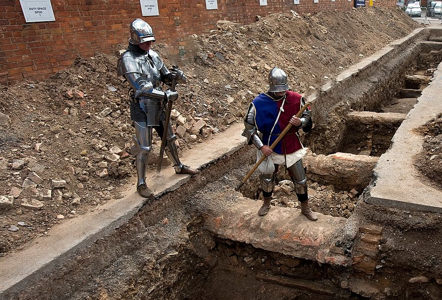 Two men dressed as medieval knights pose for pictures