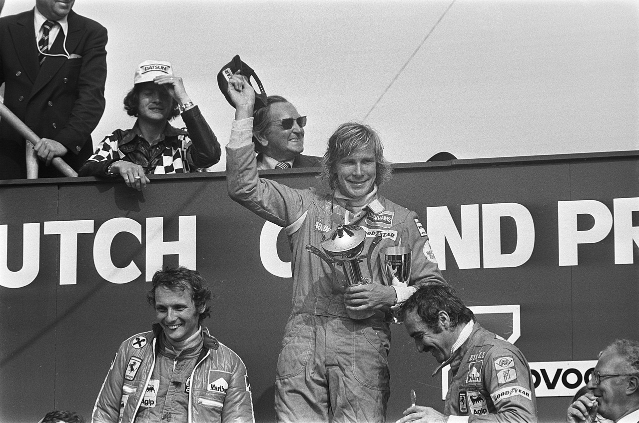 The race winner, Hesketh's James Hunt, stands on the top step of the podium at the 1975 Dutch Grand Prix