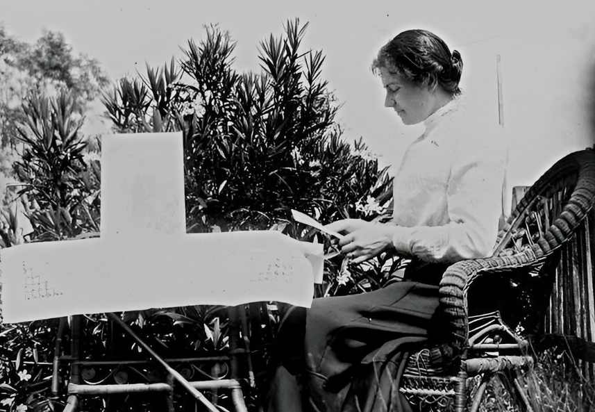 Young woman reading a letter in a garden