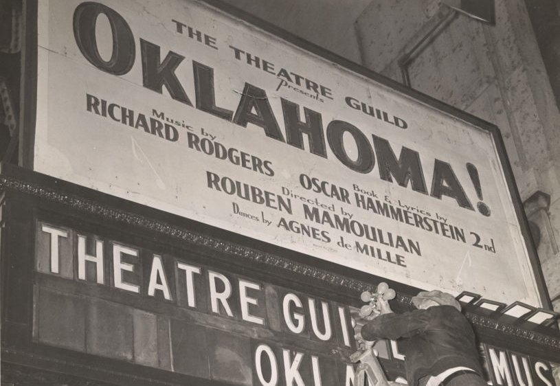 View of a man changing the light bulbs under the marquee