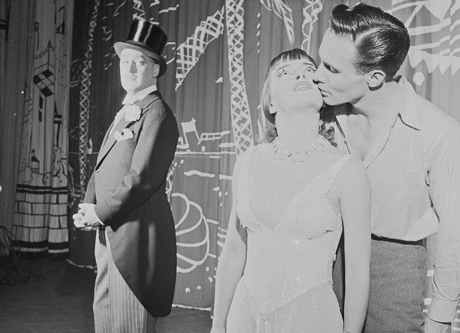 Joan McCracken receives a kiss from one of her co-stars