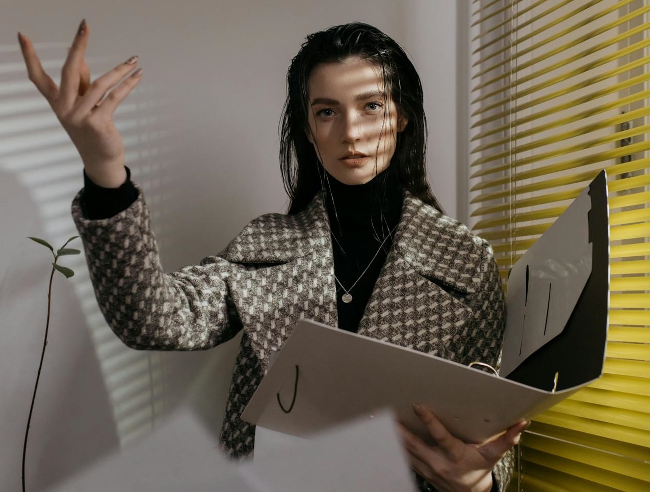 A Woman in a Coat Throwing Documents