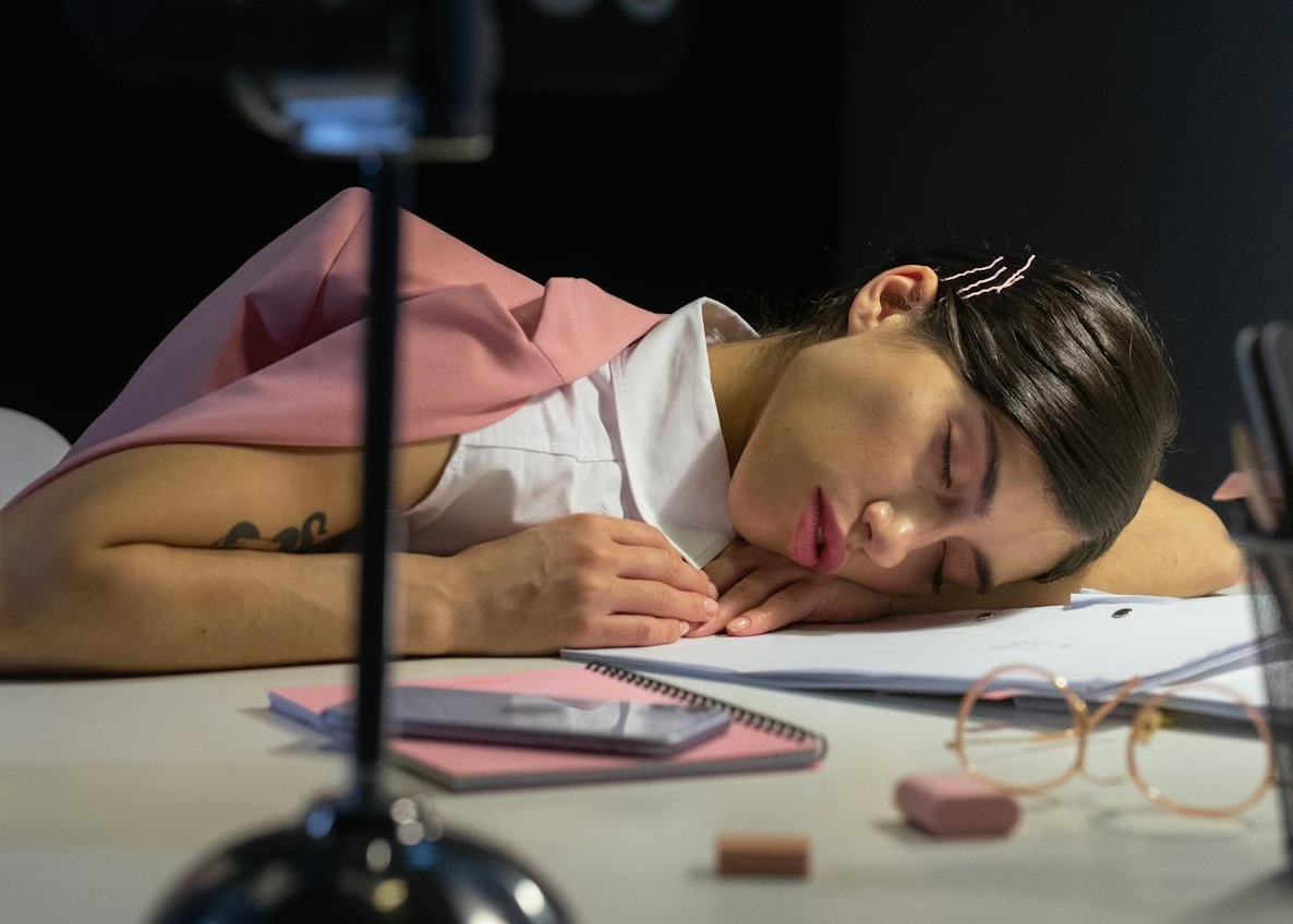 A Woman Falling Asleep on Her Desk