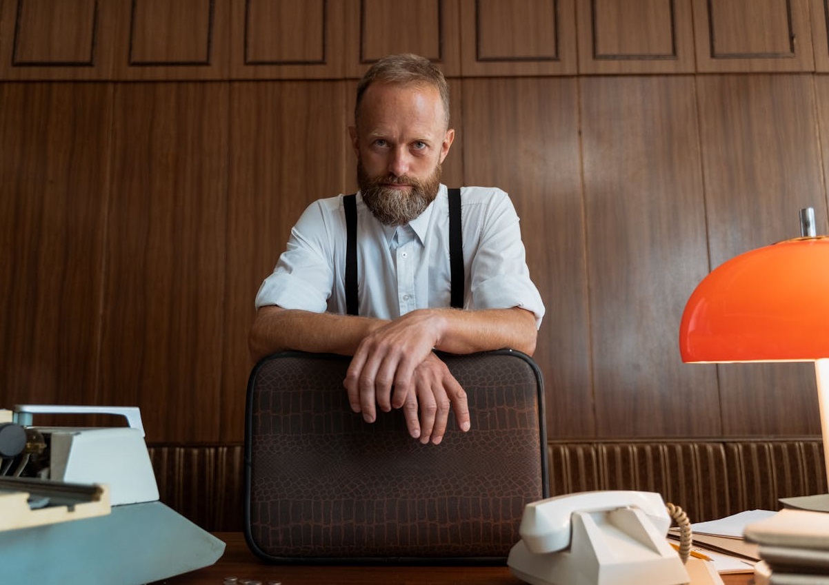 A Man Standing at his Work Desk