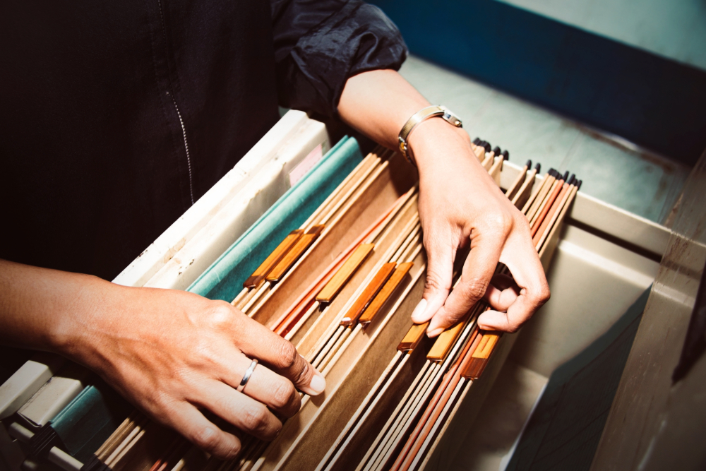 Documents in the office : Top view Bussinesswoman working hand searching Report file in drawer