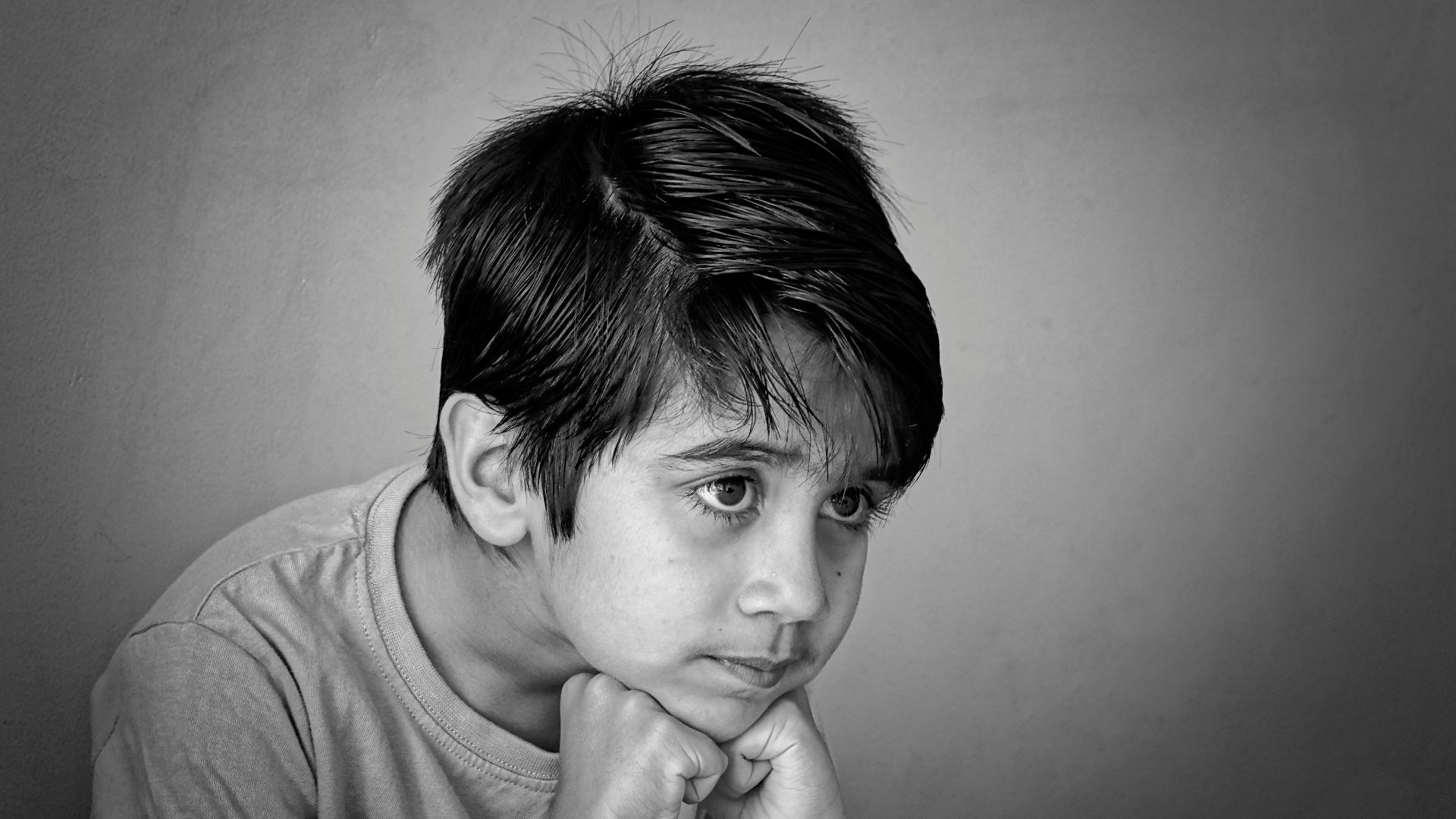 a black and white photo of a young boy