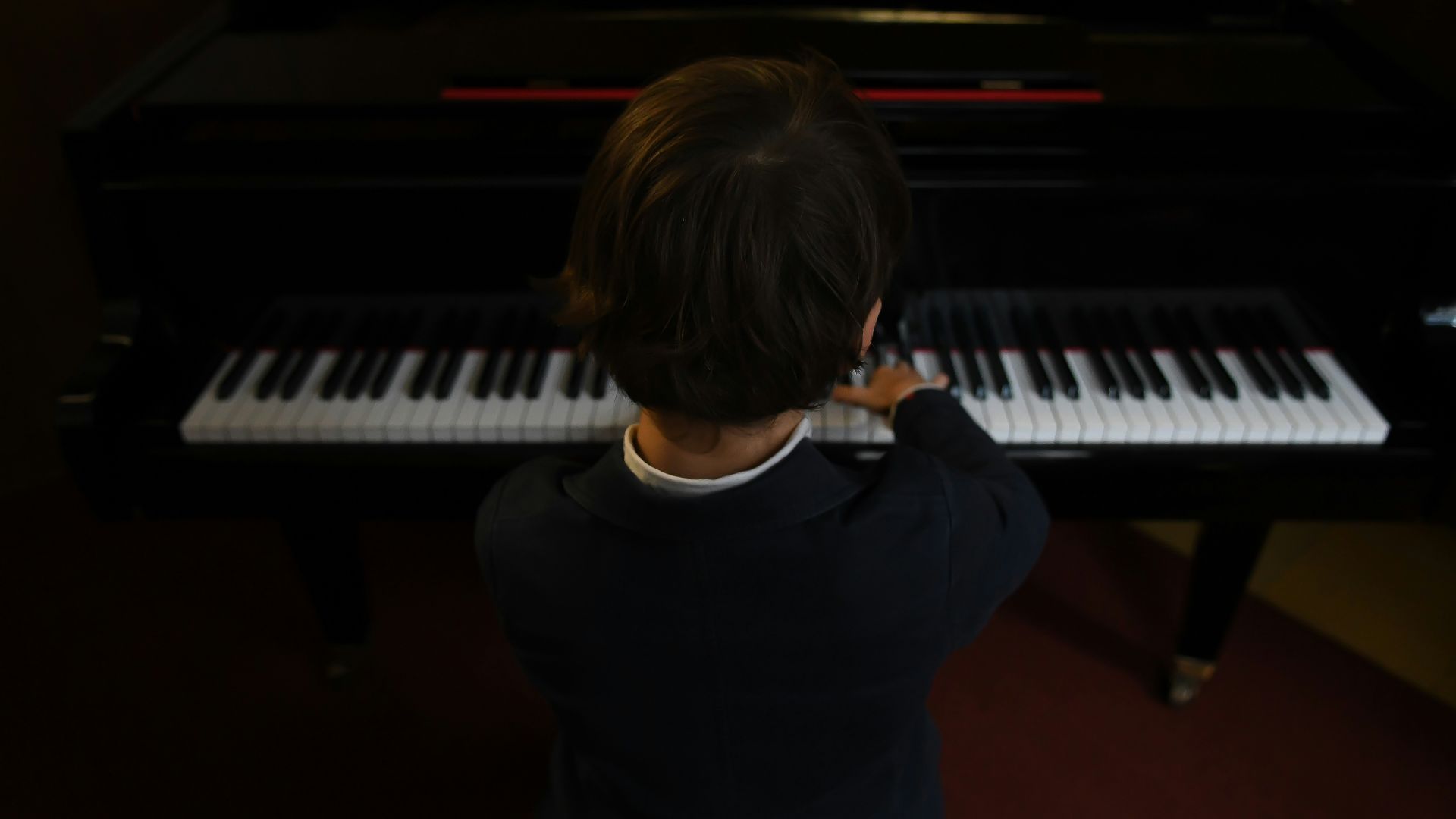boy playing a piano