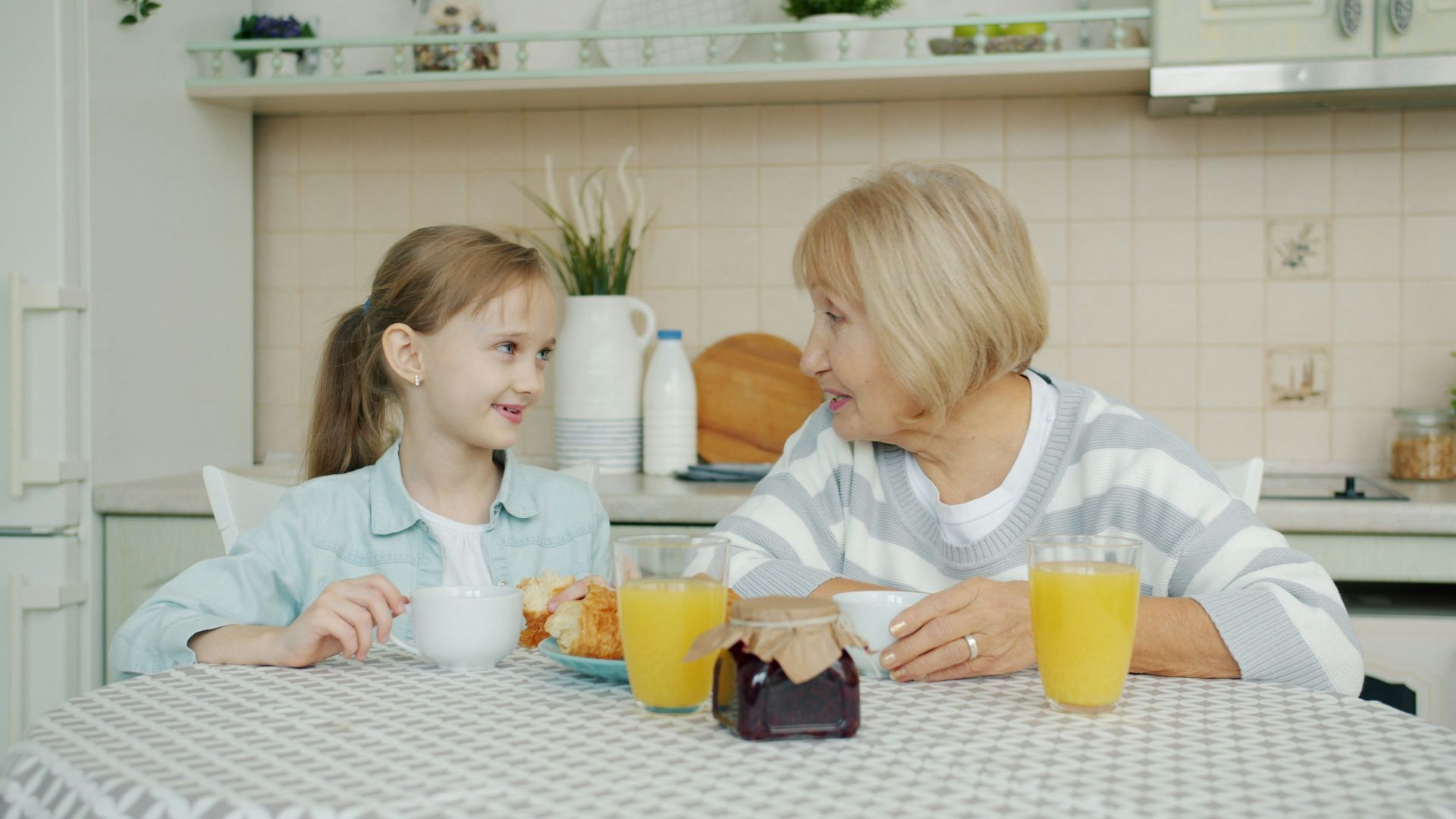 Grandmother and granddaughter enjoying breakfast together.