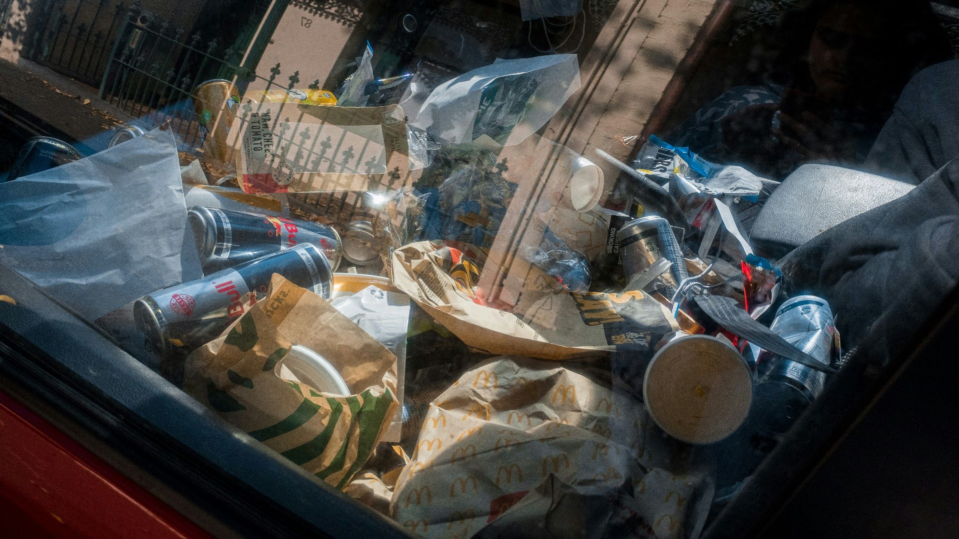 a red car parked in front of a building