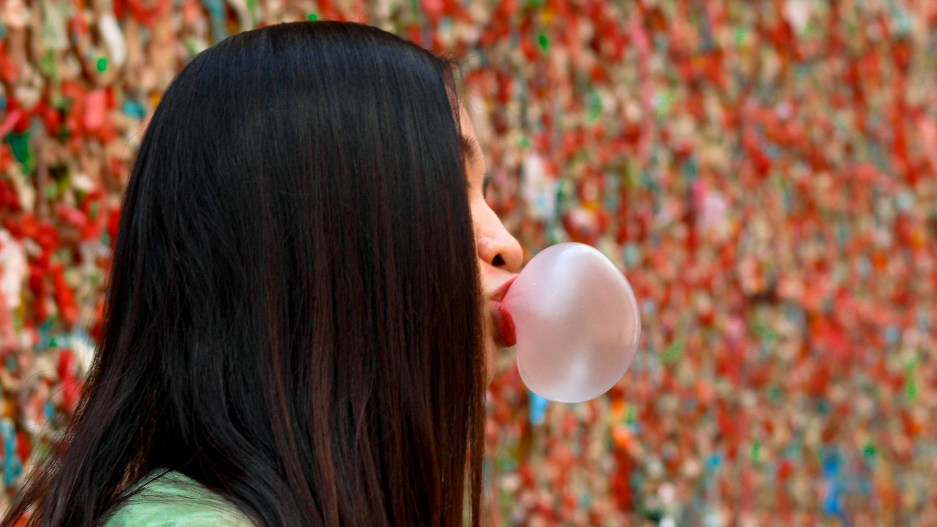 woman in green jacket looking at the sky
