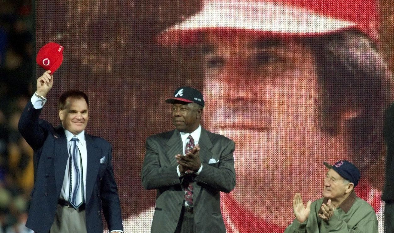 All-Century team member Pete Rose (L) tips his cap after being announced as Henry Aaron (C) and Ted Williams applaud 24 October, 1999, before game two of the 1999 World Series at Turner Field in Atlanta, GA. Rose played for the Cincinnati Reds, Aaron for the Atlanta Braves, and Williams for the Boston Red Sox. It was Rose's first appearance at an official baseball event since he was banned from the game 11 years ago. The New York Yankees have a 1-0 lead in the best-of-seven series.