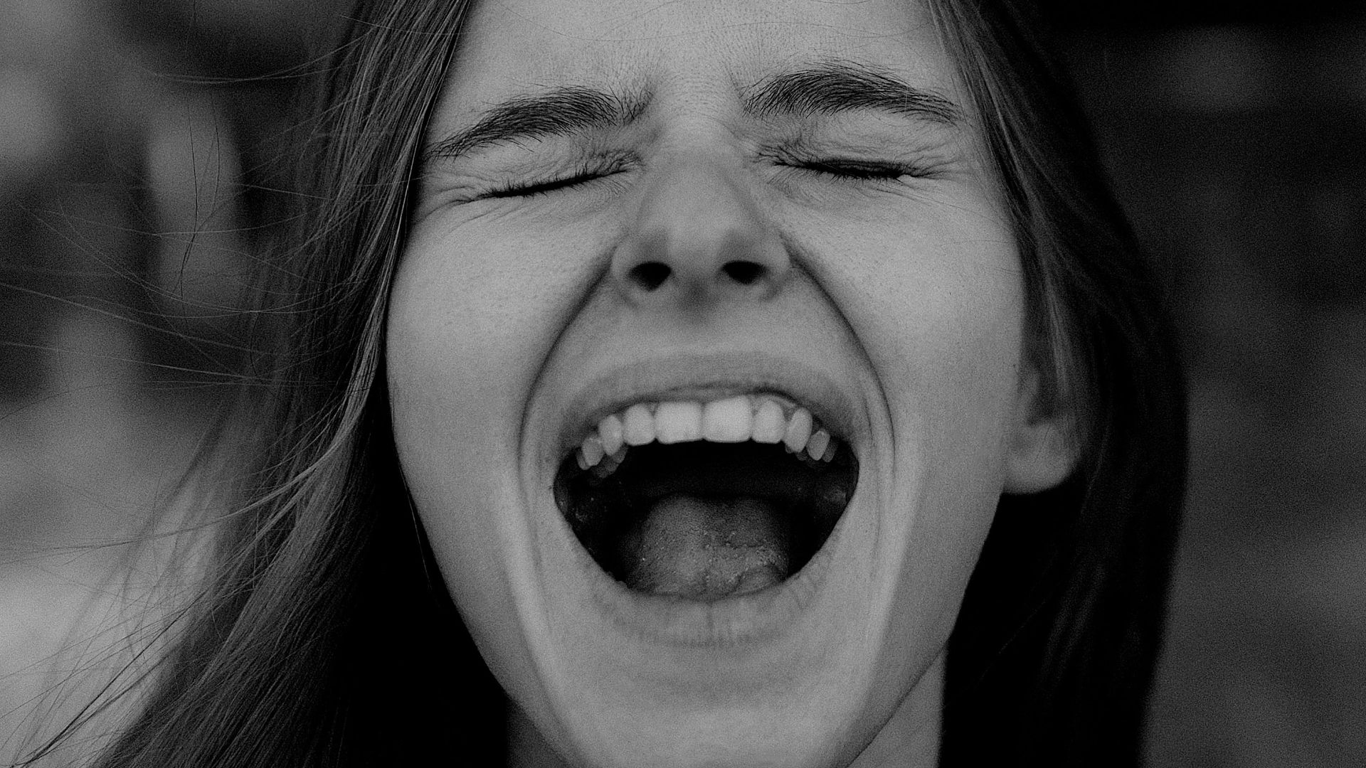 a woman with her eyes closed and mouth wide open