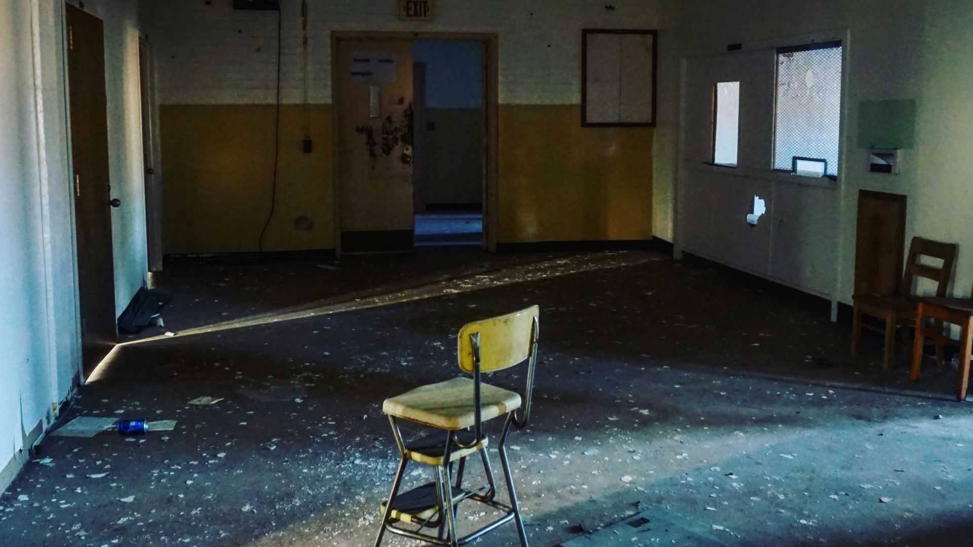 brown wooden chair near white wall
