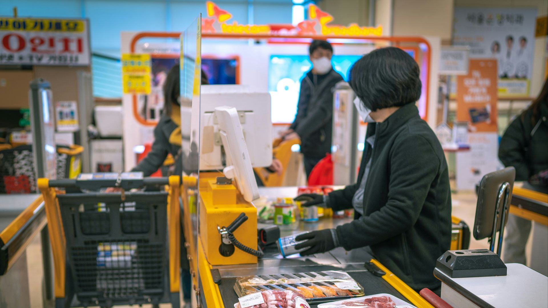 a woman standing at a cash register in a store