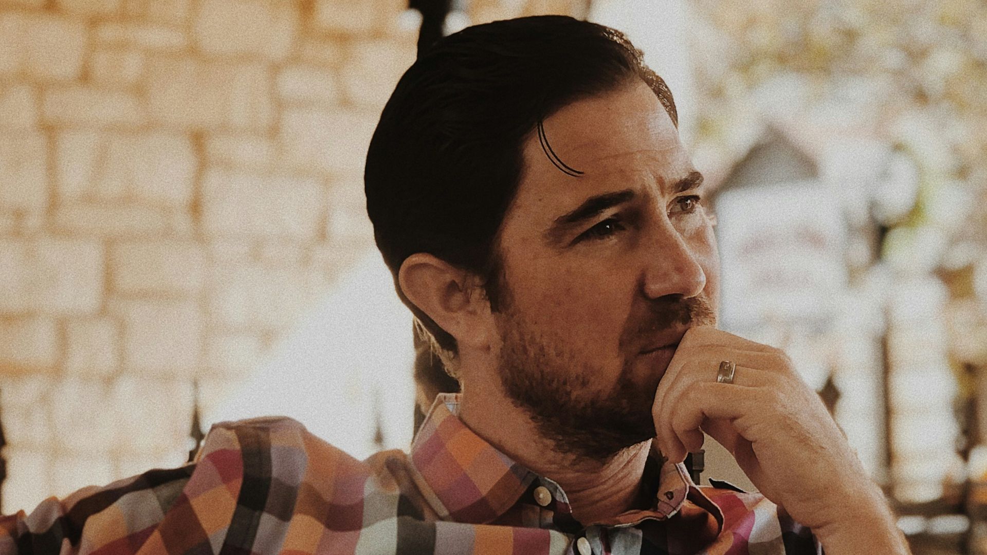 man in red and black plaid dress shirt