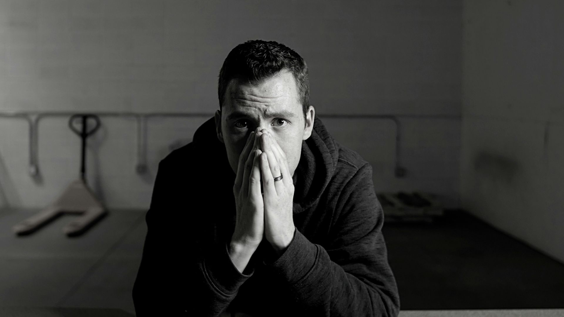 man in black jacket sitting on floor