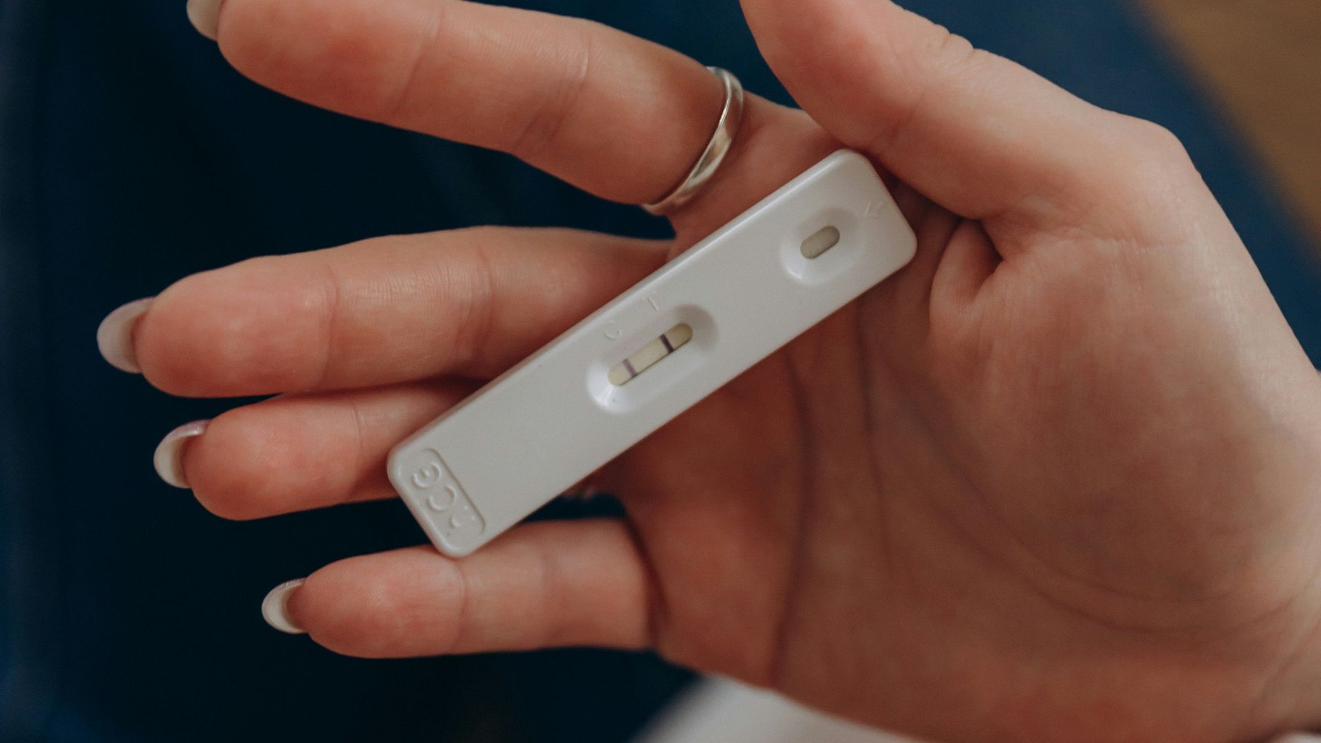 a hand holding a video game remote control