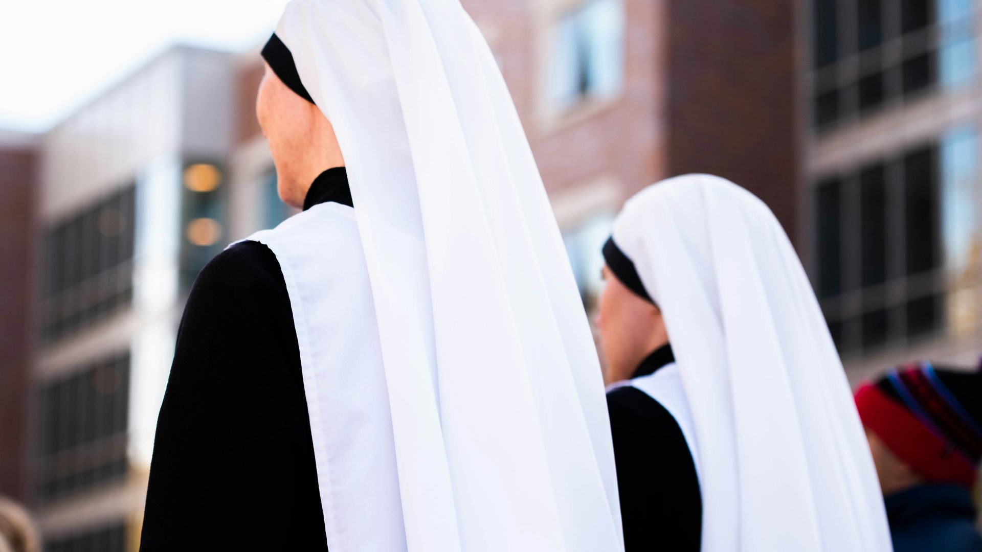 a group of women dressed in black and white