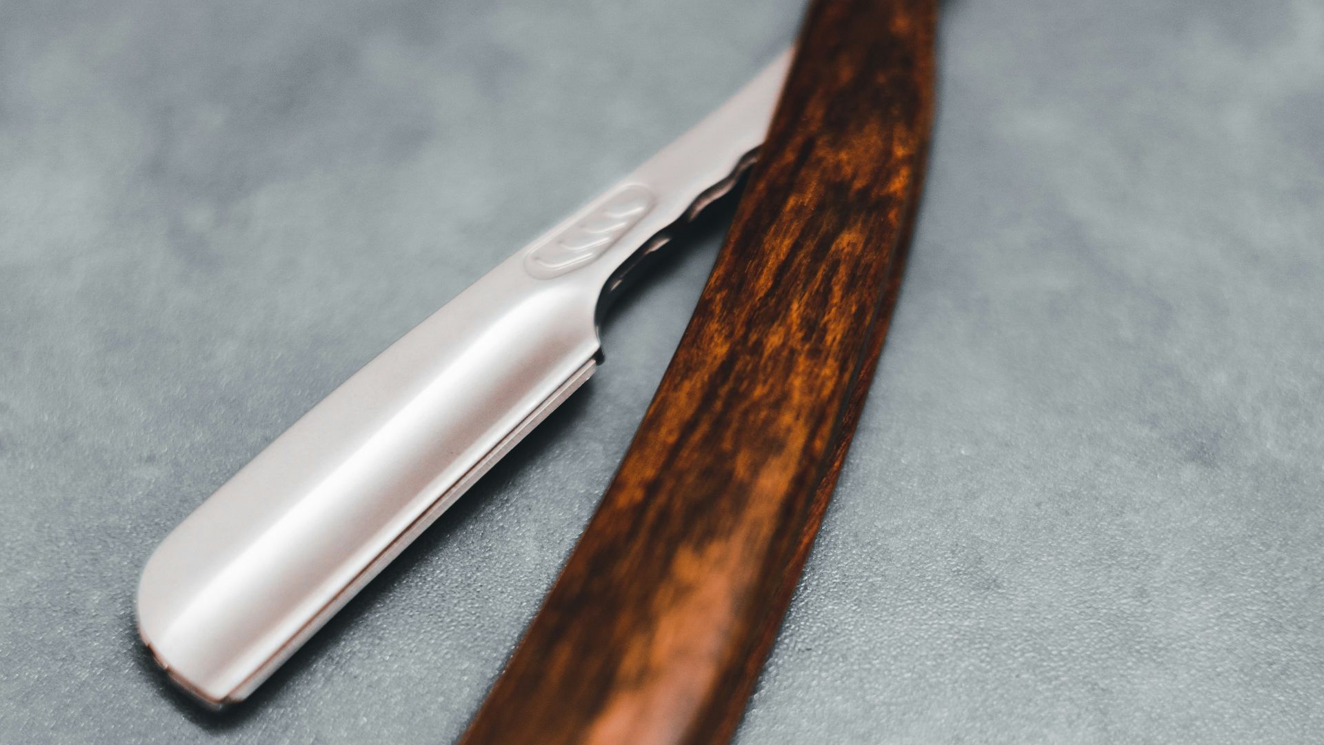 brown handle knife on blue textile
