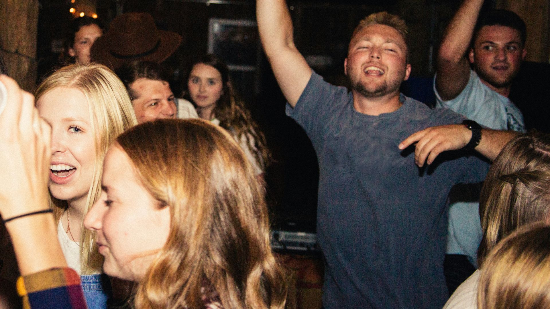 man in black crew neck t-shirt holding white ceramic mug