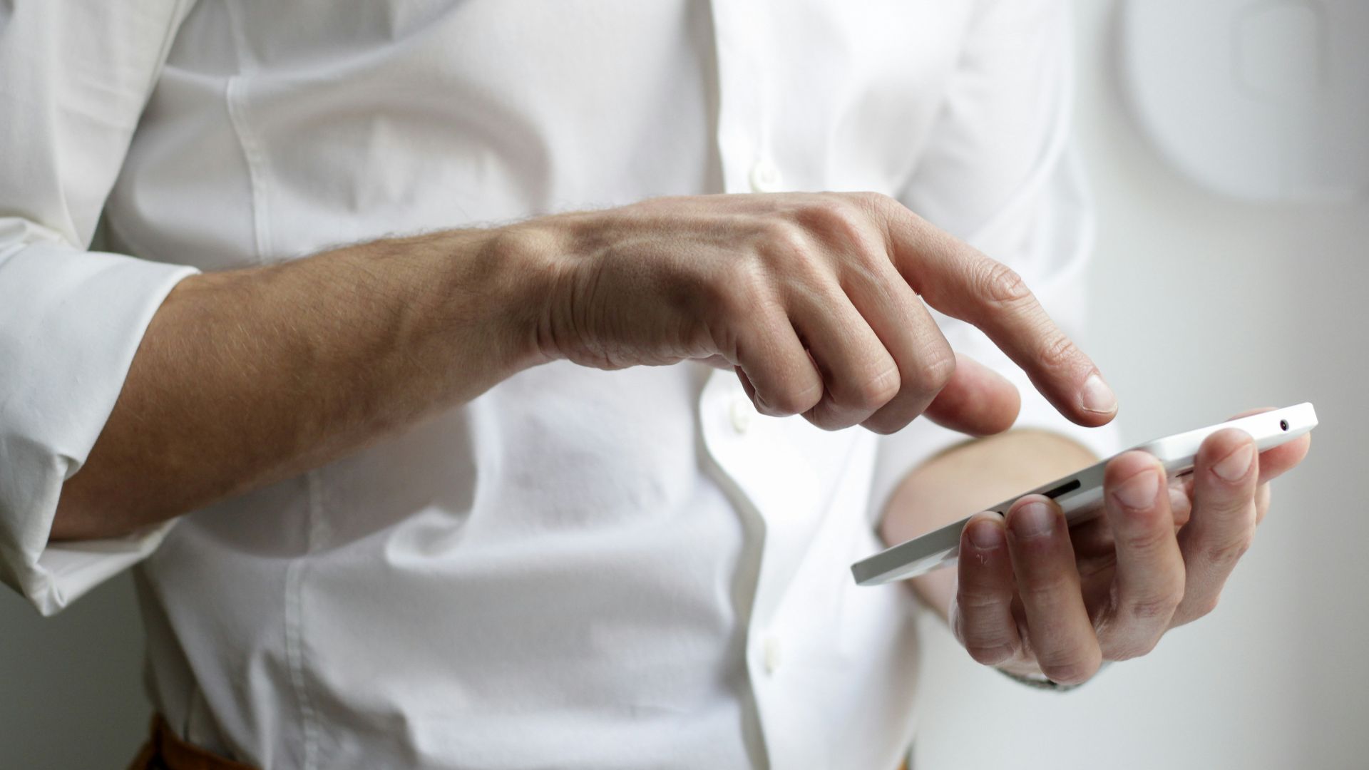 person holding white Android smartphone in white shirt