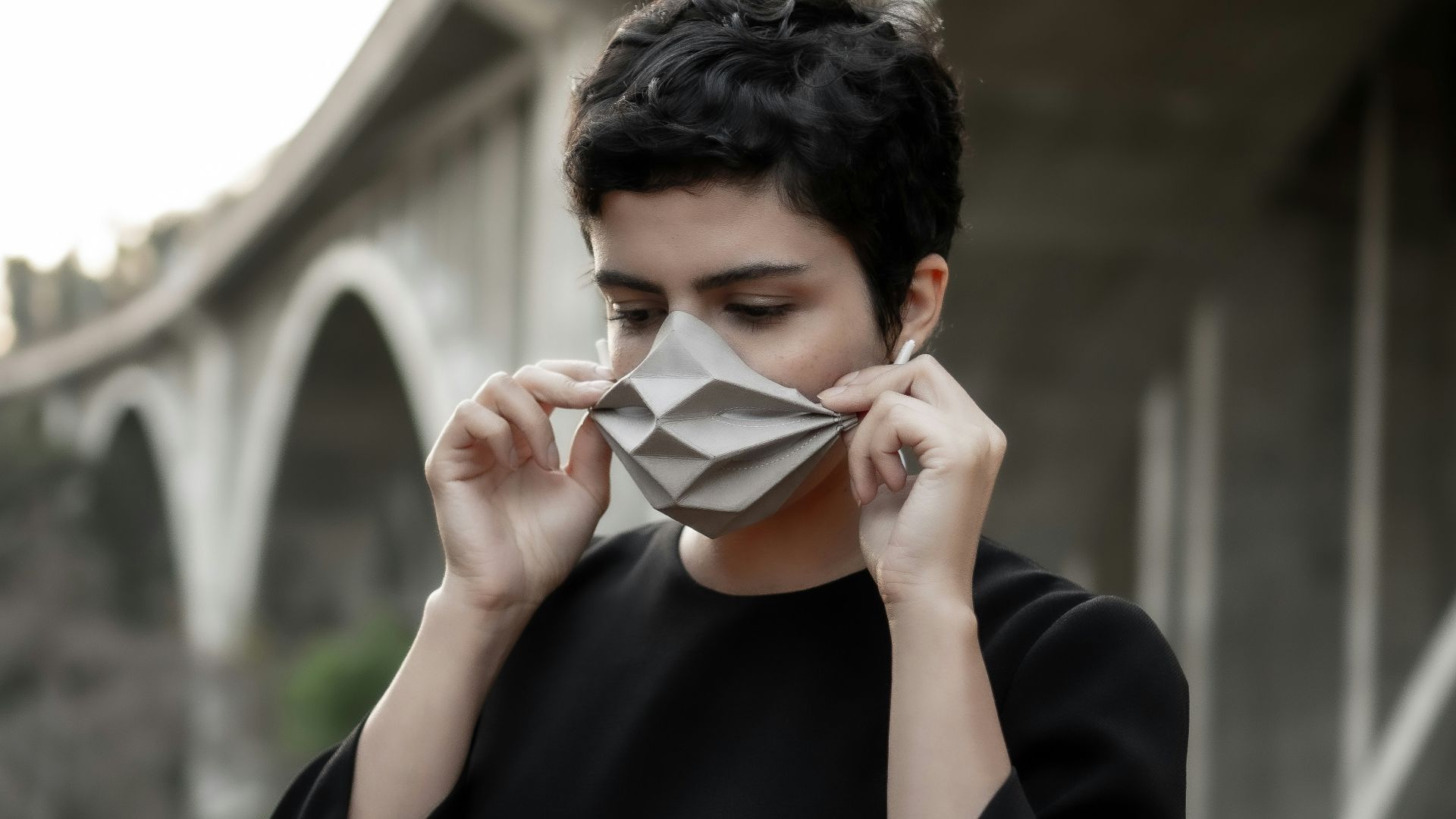 man in black long sleeve shirt holding white paper