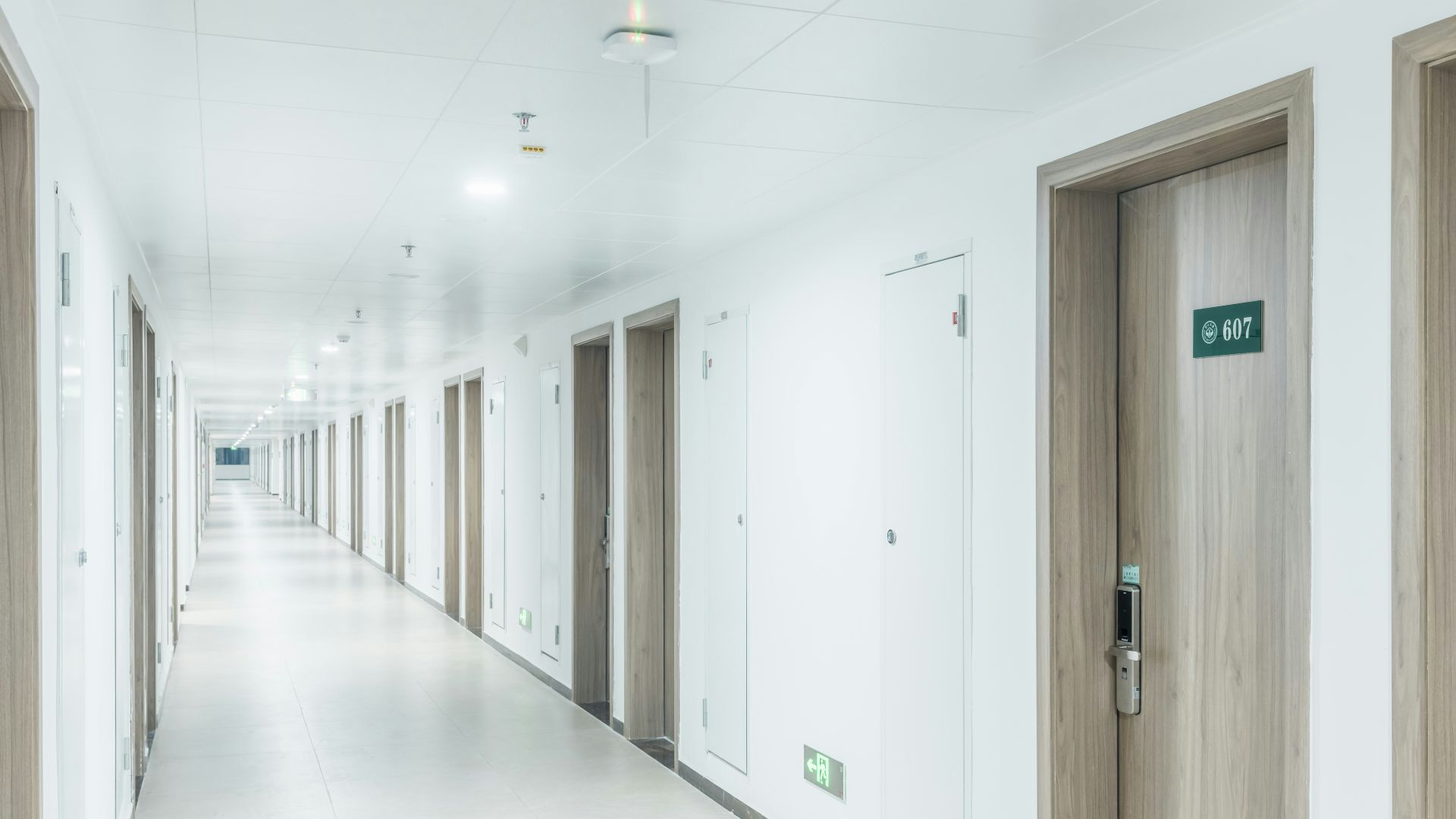 a long hallway with doors leading to another room