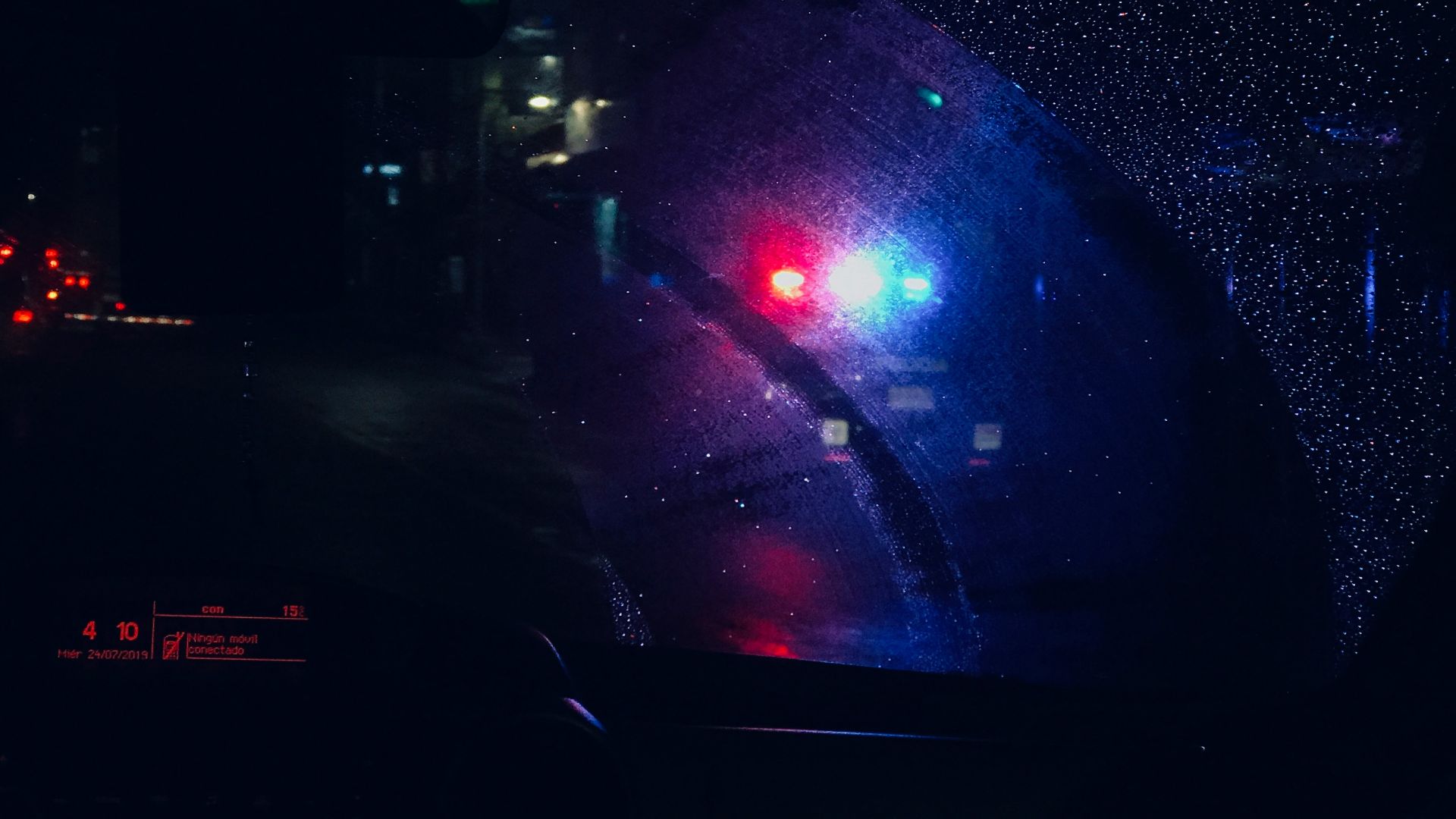 a close up of a car's rear view mirror at night