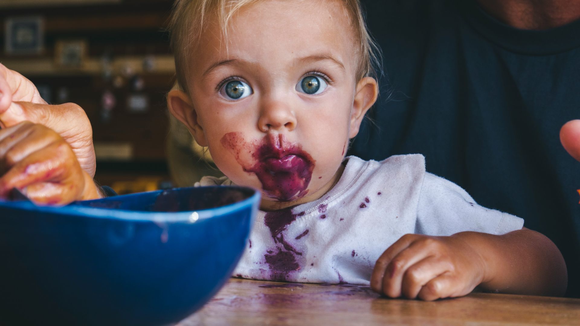 a little girl with food all over her face