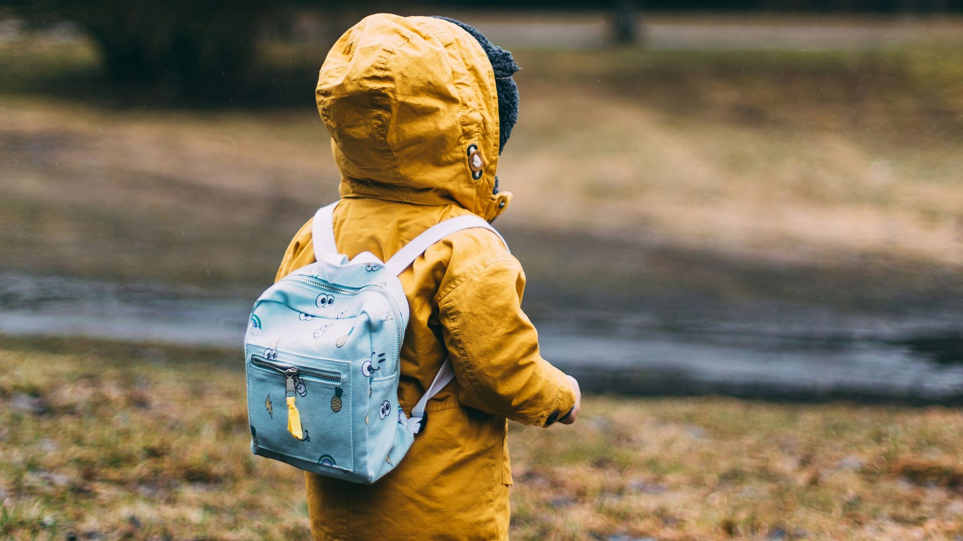 shallow focus photo of toddler walking near river