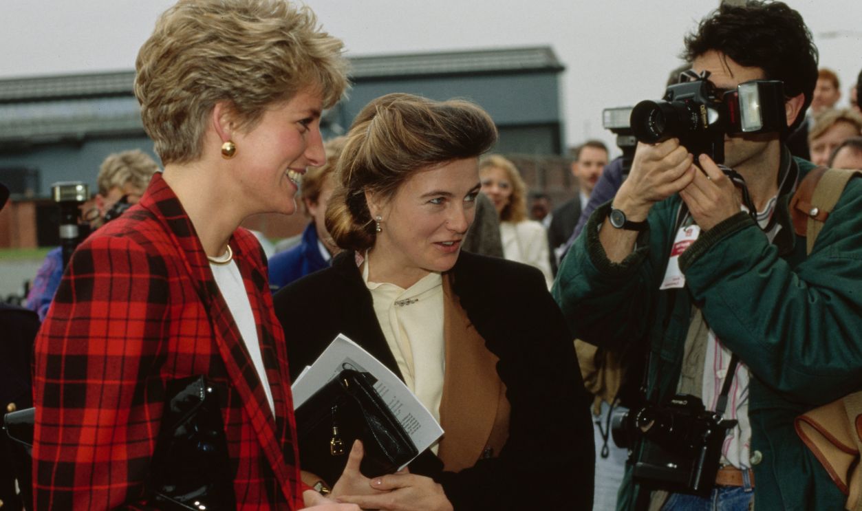 Princess Diana stands beside the Marchioness of Douro Princess Antonia of Prussia surrounded by a crowd of people at a Guinness Trust Project in Manchester, England, March 1991.