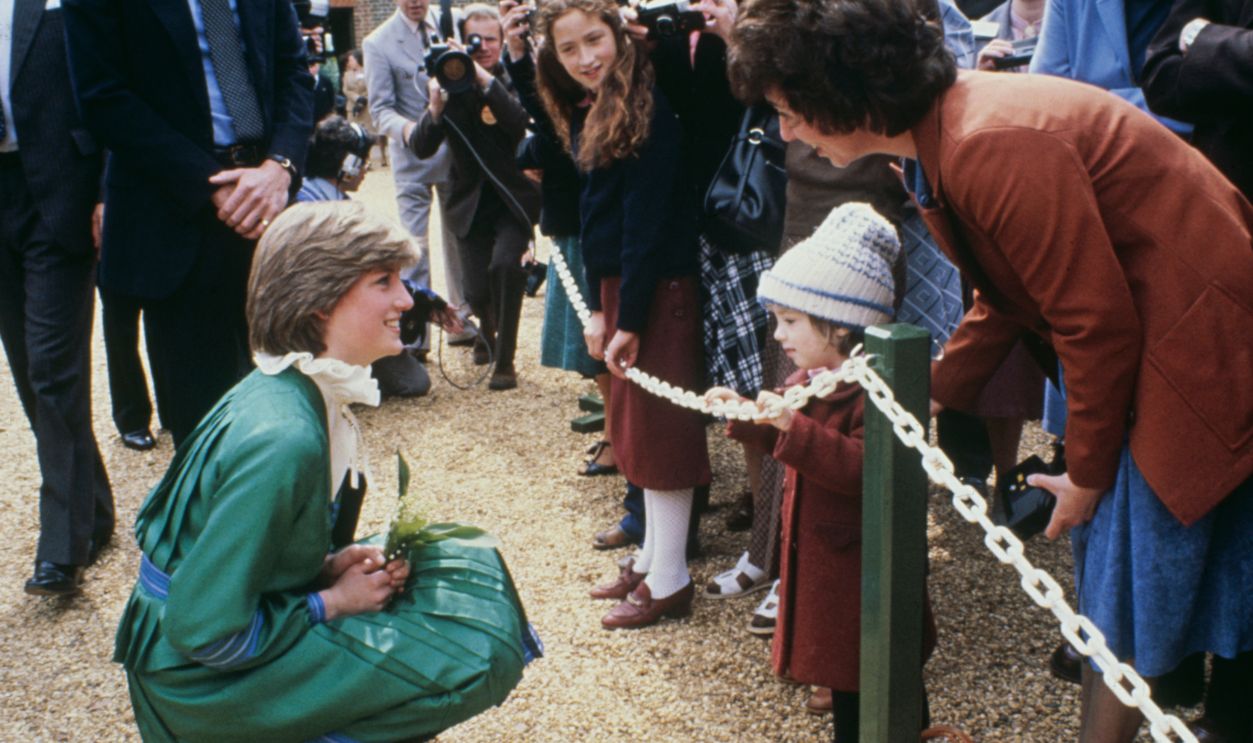 Lady Diana Spencer (later Princess Diana), wearing a green dress and holding a bouquet of flowers, meets members of the public during a visit to Broadlands in Romsey, Hampshire, on May 9th, 1981.