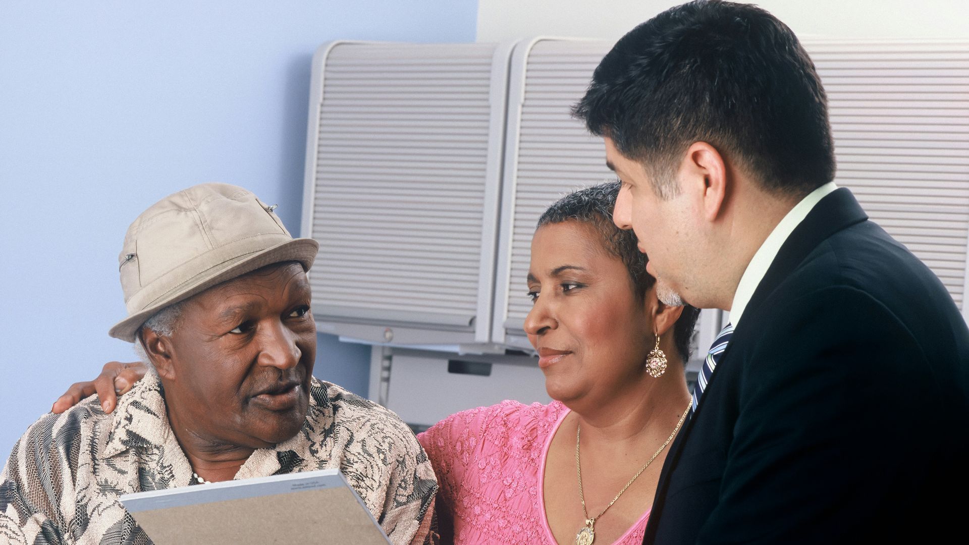 man in black suit jacket and woman in pink and white floral dress
