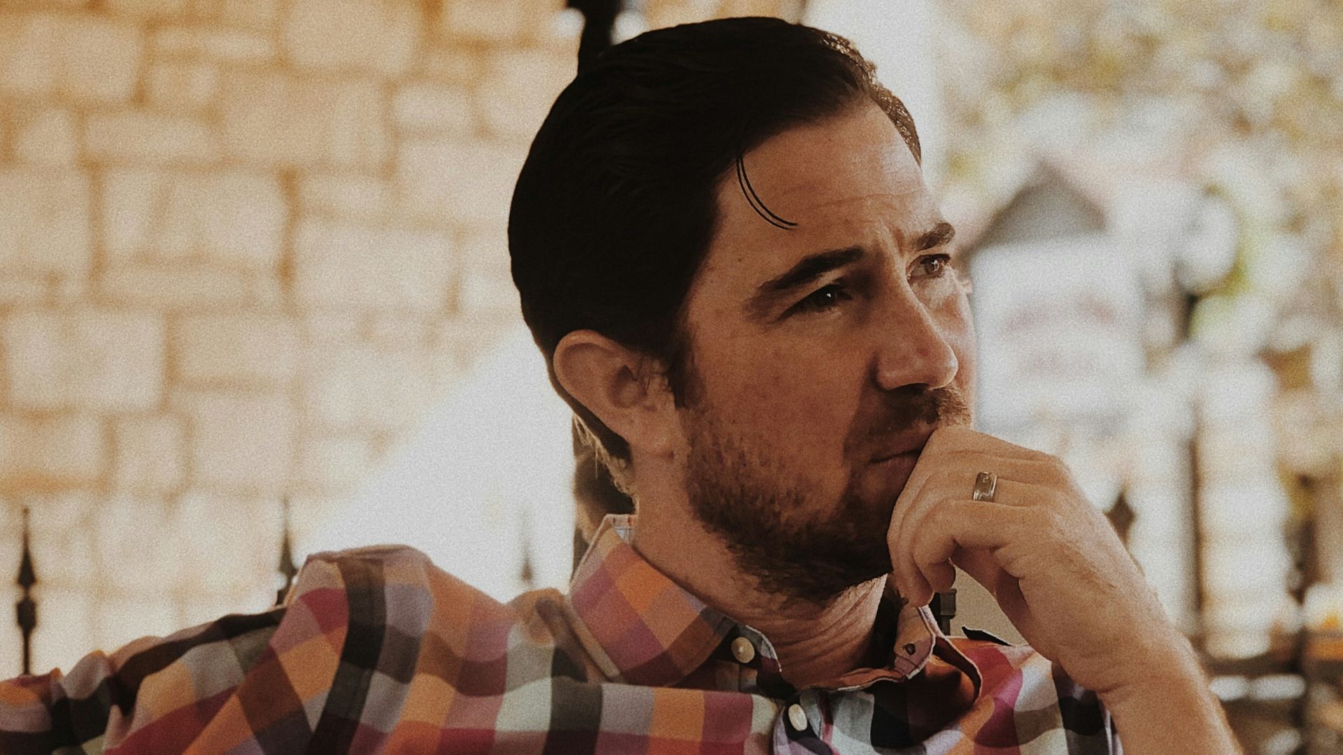 man in red and black plaid dress shirt