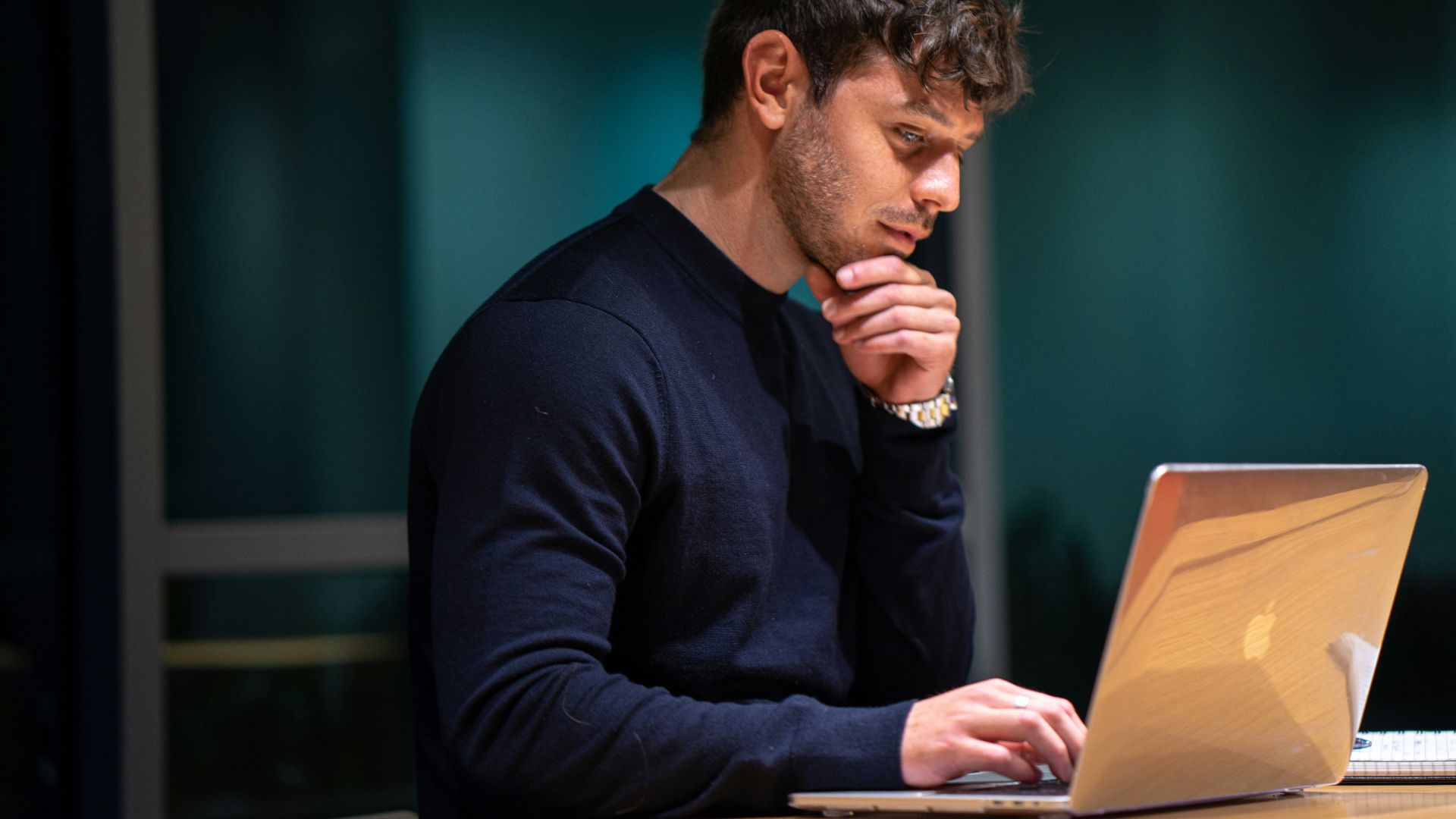 man in black long sleeve shirt sitting in front of macbook