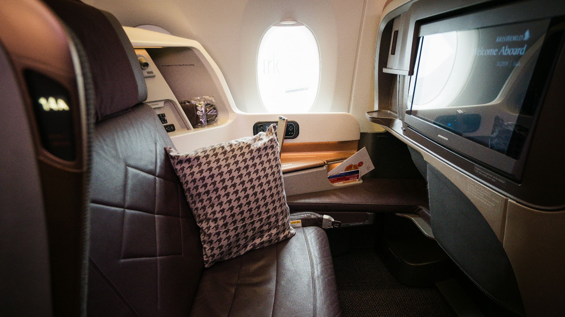 A view of the inside of an airplane with a flat screen TV
