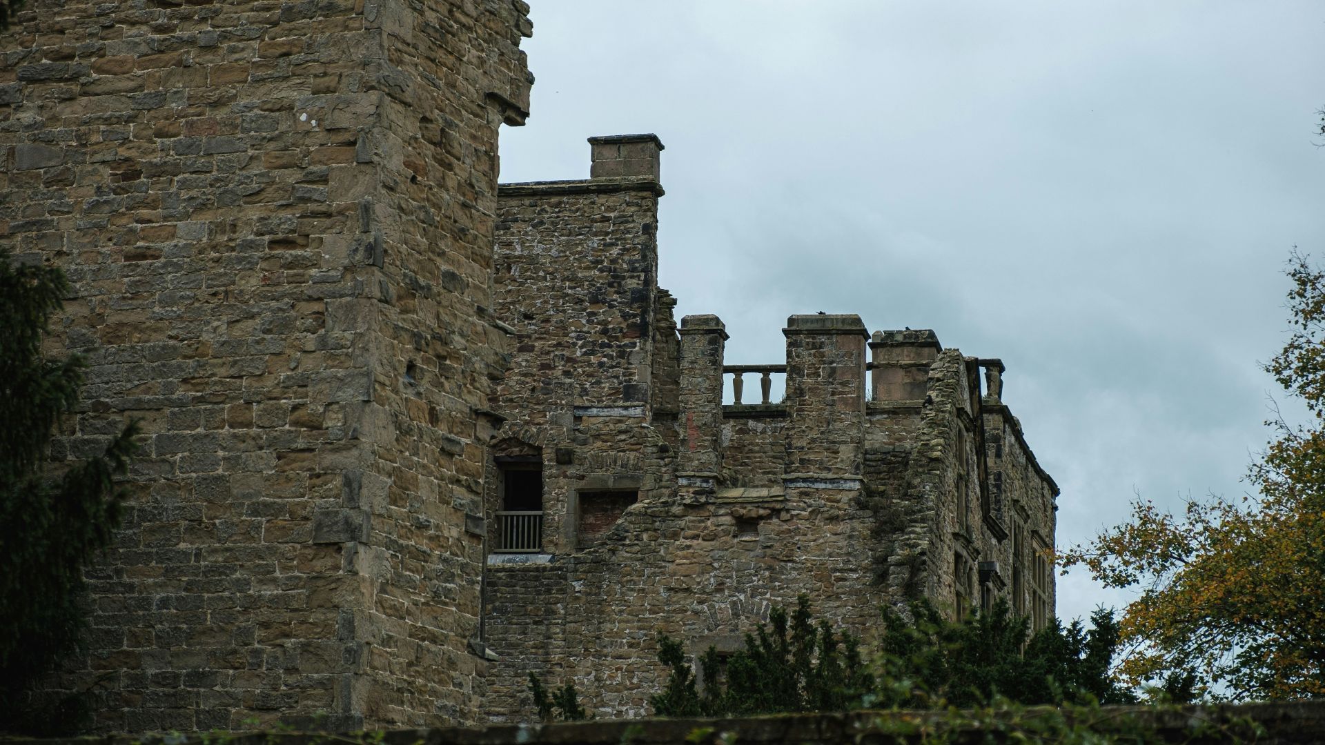 a tall brick building with a clock on it's side