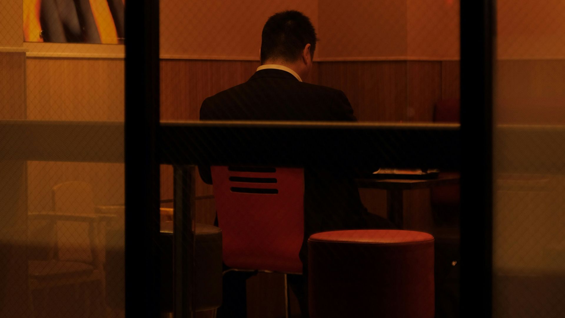 a man sitting at a table in front of a window